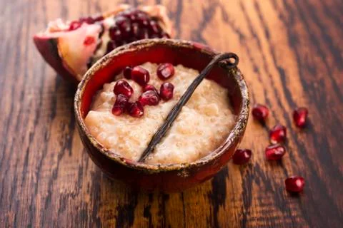 A bowl of tapioca pudding with vanilla and pomegranate Stock Photos