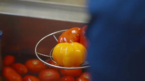 A bowl of tomatoes and oranges on a table Stock Footage 297844046