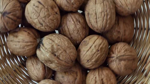 A bowl of walnuts rotate on a board Stock Footage 247247828