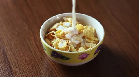 Bowl on wood table full of cornflakes soaked in milk, high definition FullHD Stock Footage 66802252