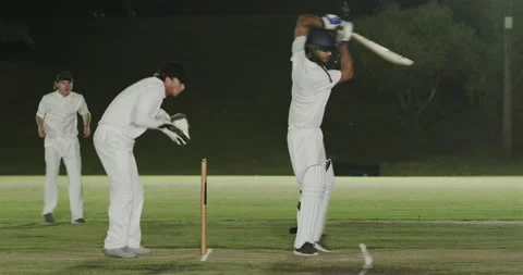 Bowler bowling, Indian man missing shot, wicketkeeper diving and dislodging Stock Footage 335808180