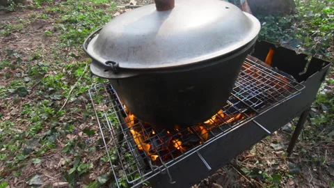 Bowler pot on fire in forest. cooking on fresh air Stock Footage 143386125