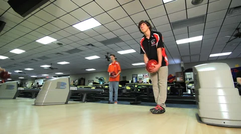 Bowler rolls ball down lane Stock Footage 32691441