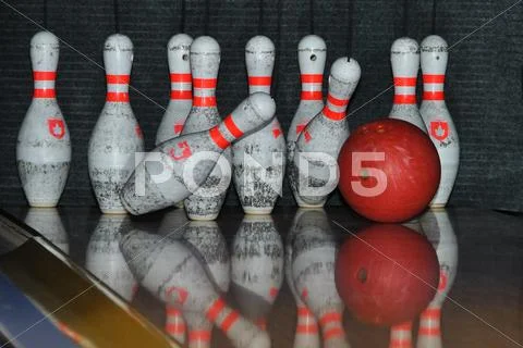 Bowling ball hits pins Stock Photos