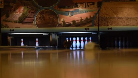 Bowling ball knocks down all pins - strike. Bowling ball on the track Stock Footage 122593092