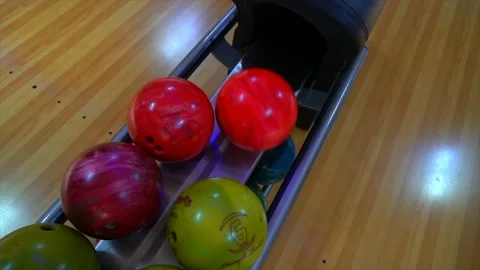 Bowling Ball out of Ball Return.Bowling game. Bowling balls lie on stand close Stock Footage 97033002