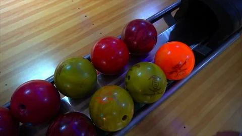 Bowling Ball out of Ball Return.Bowling game. Bowling balls lie on stand close Stock Footage 97033185