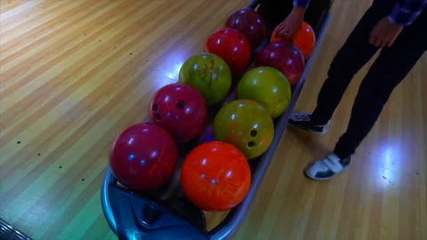 Bowling Ball out of Ball Return.Bowling game. Bowling balls lie on stand close Stock-Footage 97033707