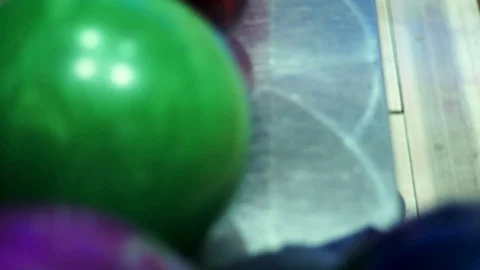 Bowling balls on return machine slow motion Stock Footage