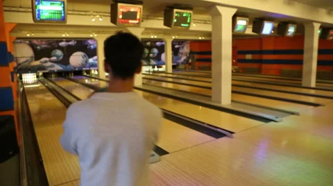 Bowling - man rolls the ball and knocks down pins Stock Footage