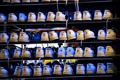 Bowling shoes rack with different sizes. Blue lighting. Stock Photos