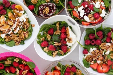 Bowls with fruit salad on table Stock Photos