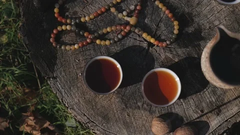 Bowls with pu-erh tea stand on a wooden stump. traditional Chinese tea Stock Footage 229859132