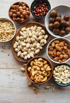 Bowls with various  nuts on a table Foto stock