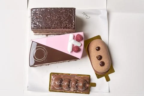 A box of assorted chocolate items on a white table Stock Photos