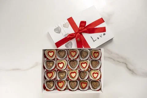 Box of assorted chocolates with a red bow and the word love top view. Stock Photos