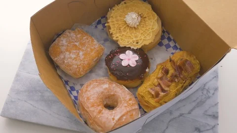 Box of Assorted Donuts to Celebrate National Doughnut Day Stock Footage 106089013