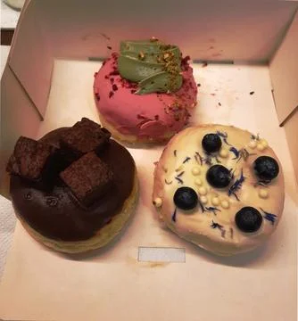Box of assorted donuts ready for takeaway or delivery Stock Photos