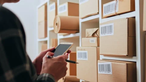 Box with barcode, Small business owners Joyfully Working with database in e- Stock Footage 234723765