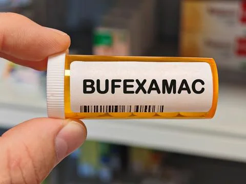 Box of BUFEXAMAC tablets on a hospital pharmacy table used to relieve skin Stock Photos