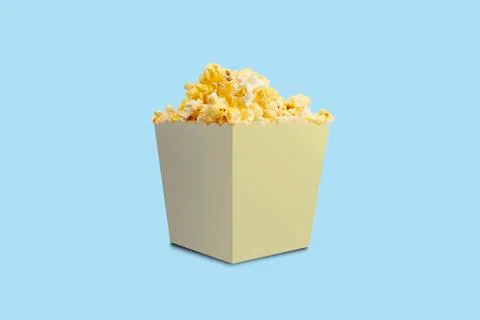 Box of buttered popcorn on blue background. Stock Photos