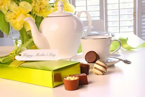 Box of chocolates on table with tea set Stock Photos