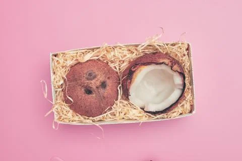 In a box coconut on a pink background isolate, copyspace, layout Stock Photos