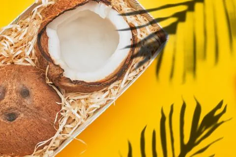 In a box coconut on a yellow background isolate, copyspace, layout Stock Photos