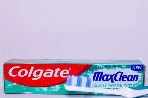 A box of Colgate max clean toothpaste and toothbrush against a white backgrou Stock Photos