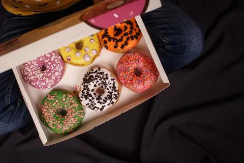 Box of colored donuts on dark background Stock Photos