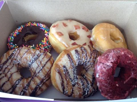 A Box of Colorful Assorted Doughnuts Stock Photos