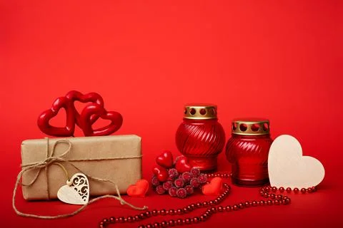 Box in craft paper with a heart made of red threads, decorative red fruits on a Stock Photos