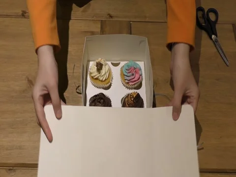 Box with cupcakes. The process of opening the box. Stock Footage 71818836