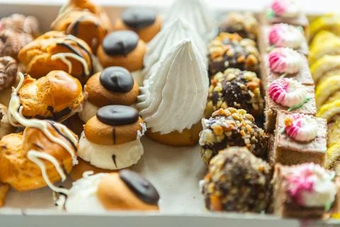 Box with different cakes on the table Stock Photos