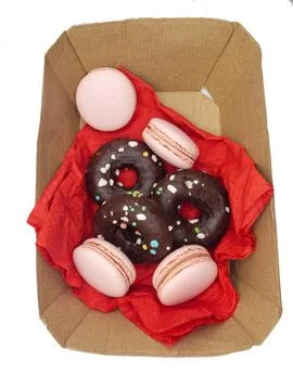 Box of doughnuts and macaroons Stock Photos