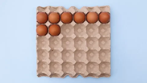 Box for eggs appear on blue theme and eggs appear in box. Stop motion Video stock 149319201