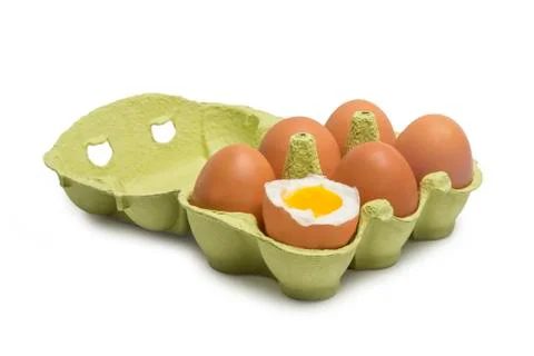 Box of eggs with one broken boiled egg Stock Photos