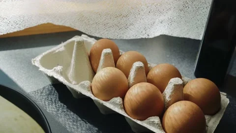 A box of eggs on the table by the window 스톡 동영상 140534279