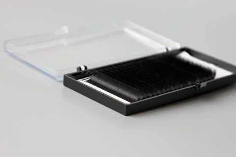 Box with false eyelashes on a gray background Stock Photos