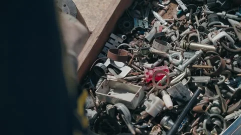 Box filled with mixed metal screws bolts and mechanical parts Stock Footage 331982566