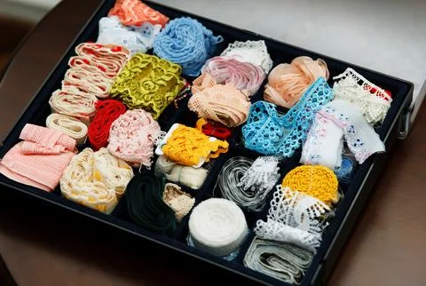 Box is filled with multicolored tapes for handmade Stock Photos