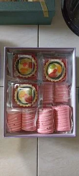 Box filled with several small cake and snack Stock Photos