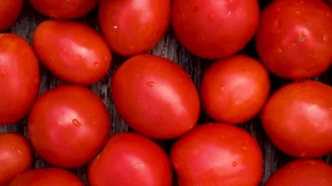 Box with fresh red tomatoes on the background of firewood. Stock Footage 203499518