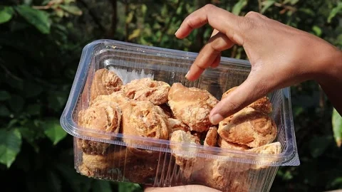 Box full of baked biscuit type of snack that is consumed with coffee or tea Stock Footage 332862236