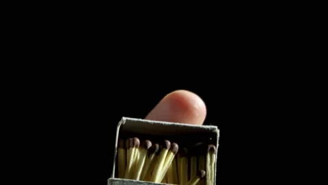 A box full of matches, covers the finger on a black background Stock Footage 153754279