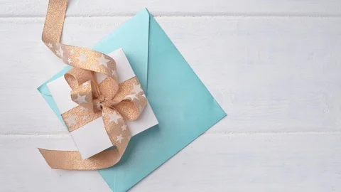 Box with a gift and an envelope on a white background. Copy space. Above Video stock 121259285