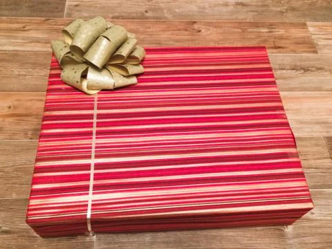 Box with a gift in a package and with a bow Stock Photos