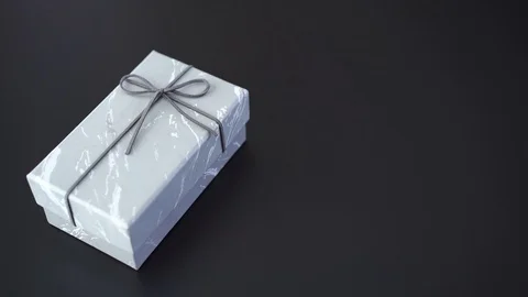 Box gift place into black background with copy space on right Stock Footage 120820698