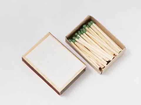 Box of green matchsticks with blank notepad on white Stock Photos
