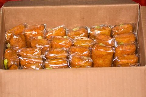 Box of individually wrapped fried snacks ready for distribution Indonesian .. Stock Photos
